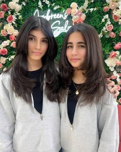 Two clients with fresh face-framing layered cuts